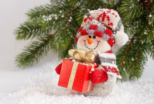 Christmas and New Year snowman with gift on New Year tree  background