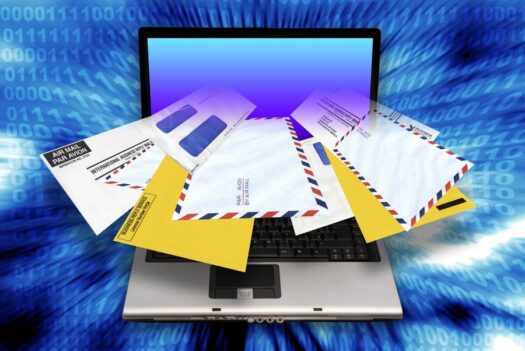 laptop computer with envelopes coming out of the screen as concept for email spam